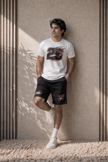 Young male model wearing a white graphic number 25 t-shirt with black printed shorts, standing in a modern beige studio background with soft natural sunlight and realistic shadows in a vertical portrait pose.