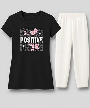 "Women's black long skirt-style t-shirt with white loose-fit summer trousers - flat lay front view - AUA&CO"