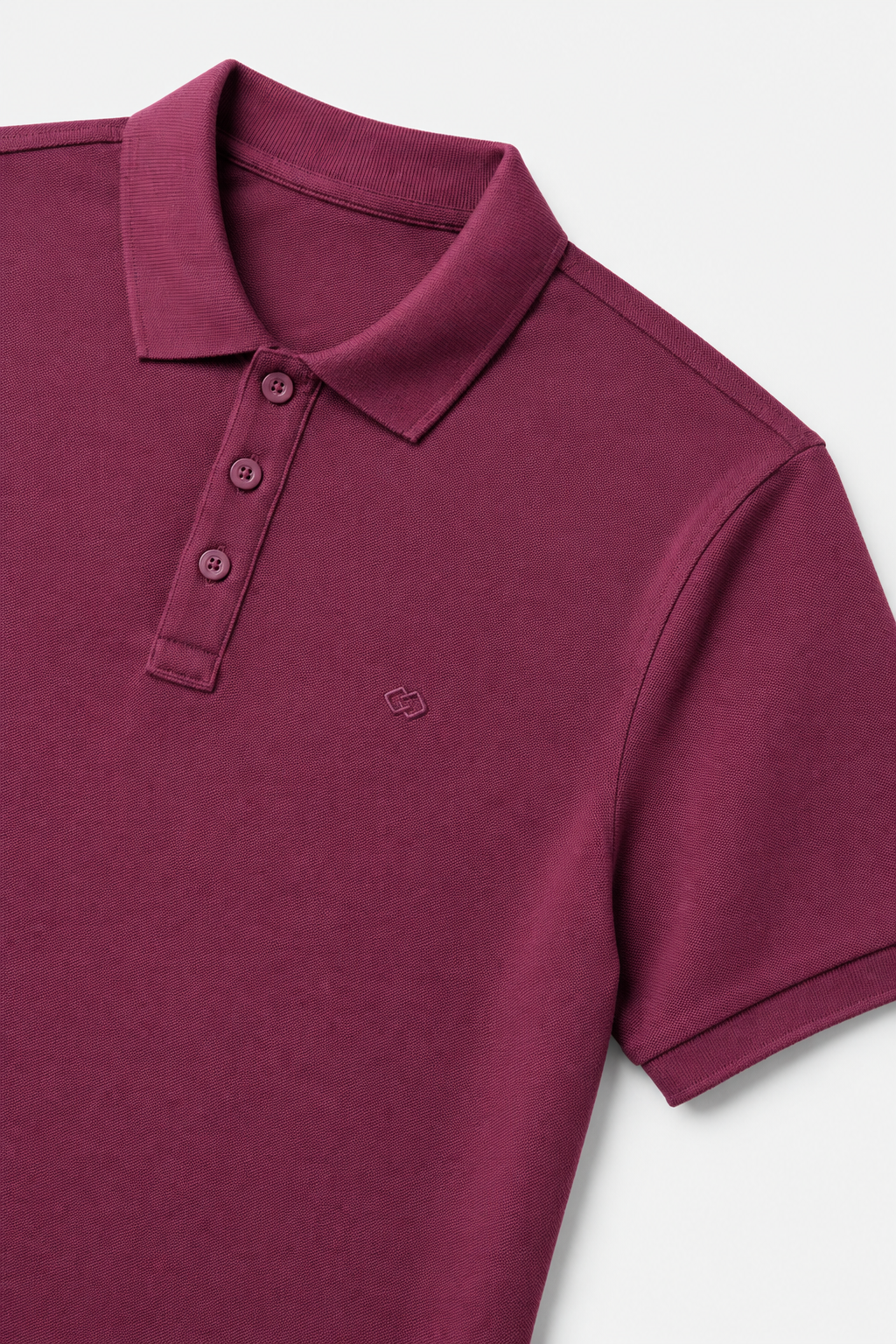 AUA&CO's Maroon polo shirt on a light gray background