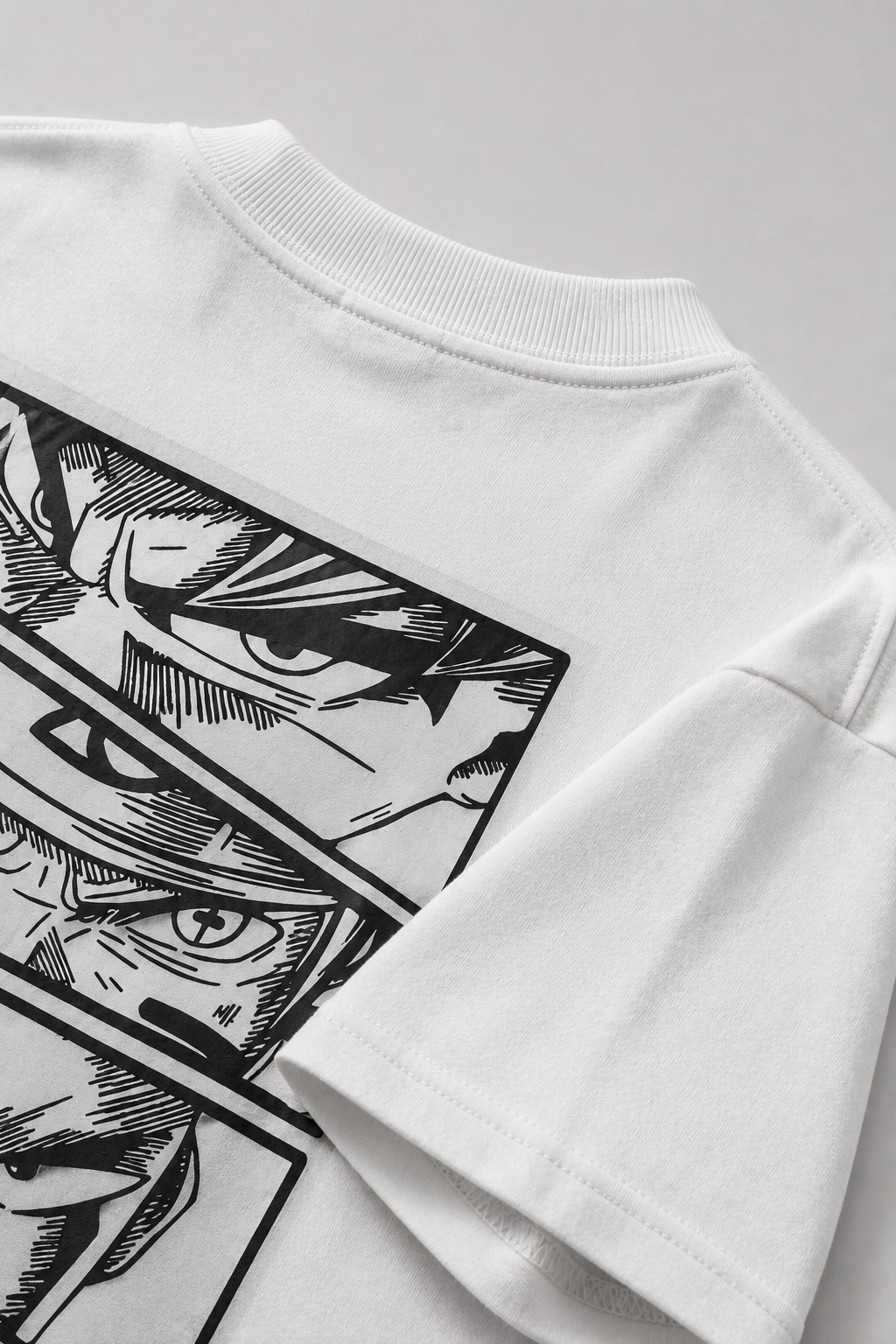 White t-shirt with black and white graphic design on a gray background