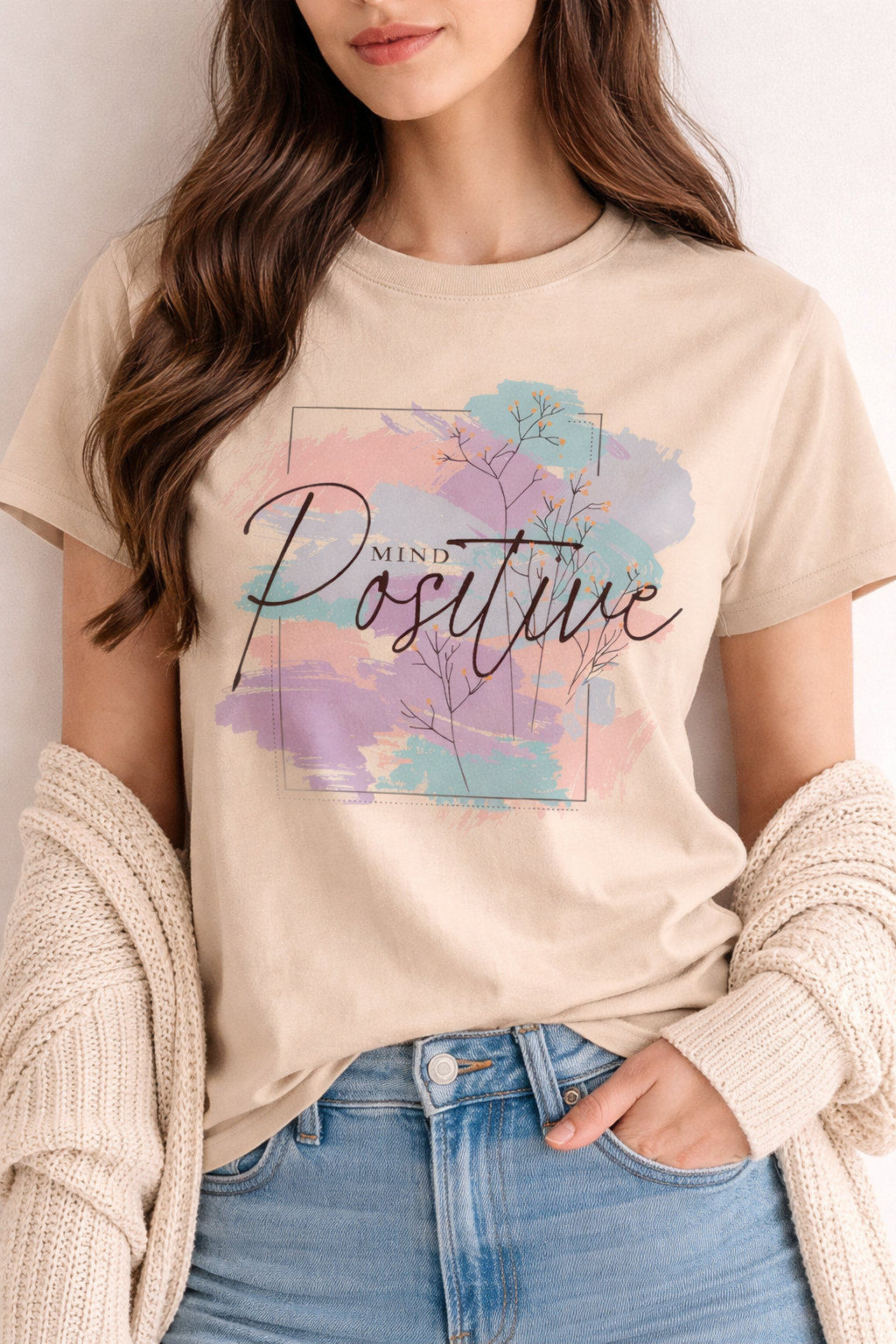 Person wearing a beige t-shirt with 'Mind Positive' design
