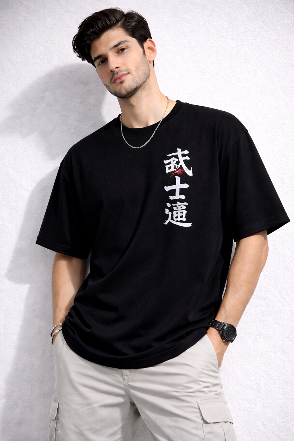 Man wearing a black t-shirt with white text against a light gray background