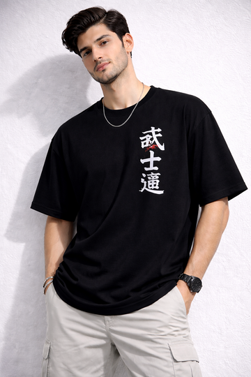 Man wearing a black t-shirt with white text against a light gray background