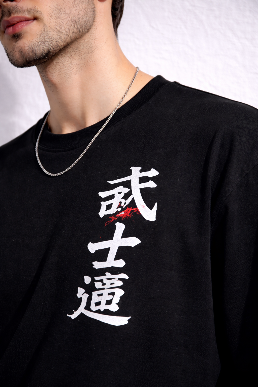Black t-shirt with white and red Japanese characters on a plain background