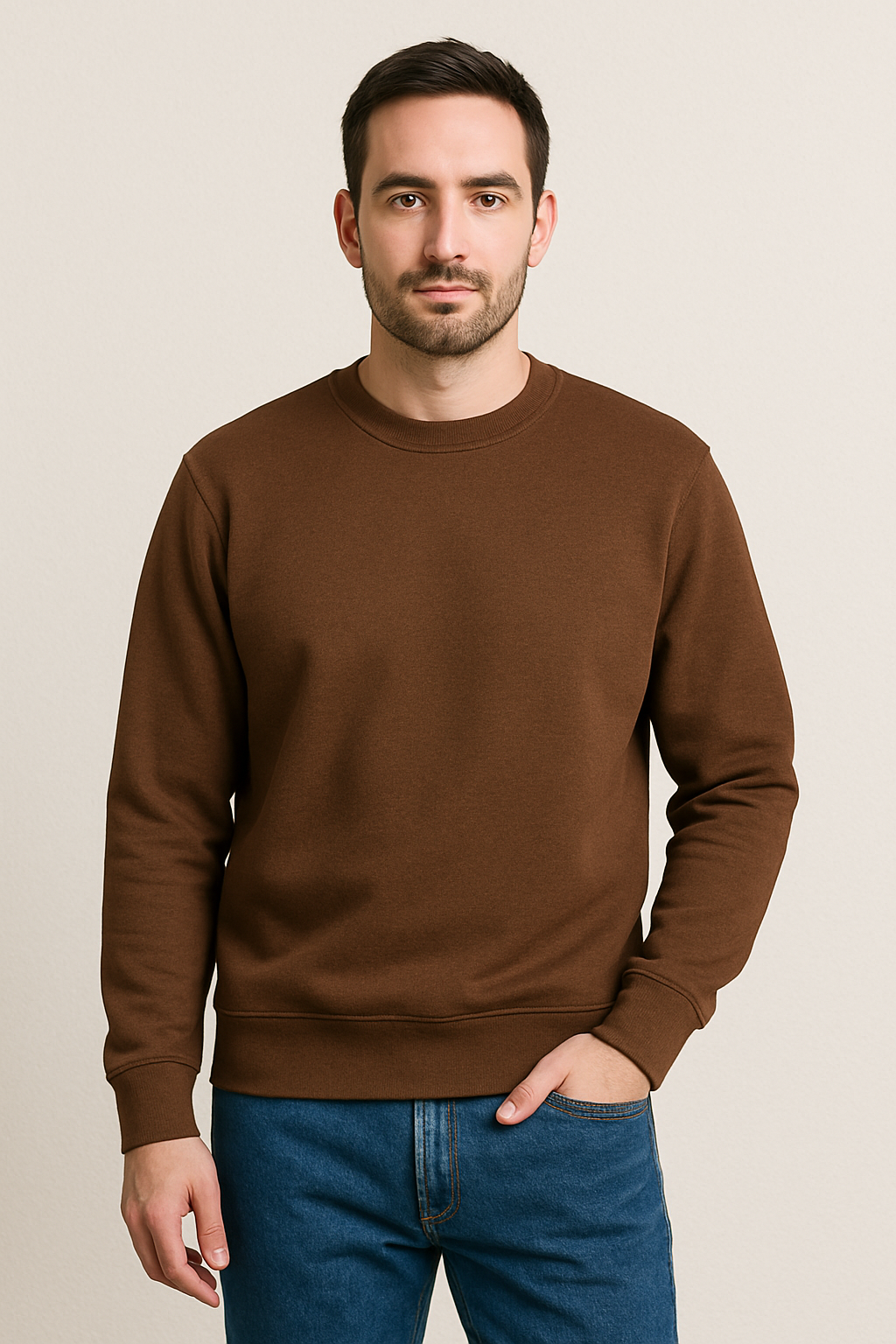 Four men wearing different colored sweatshirts against a plain background