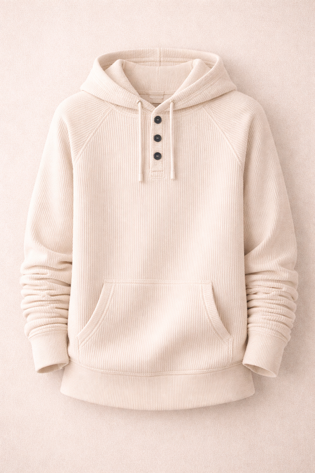 Beige hoodie with button details on a light beige background