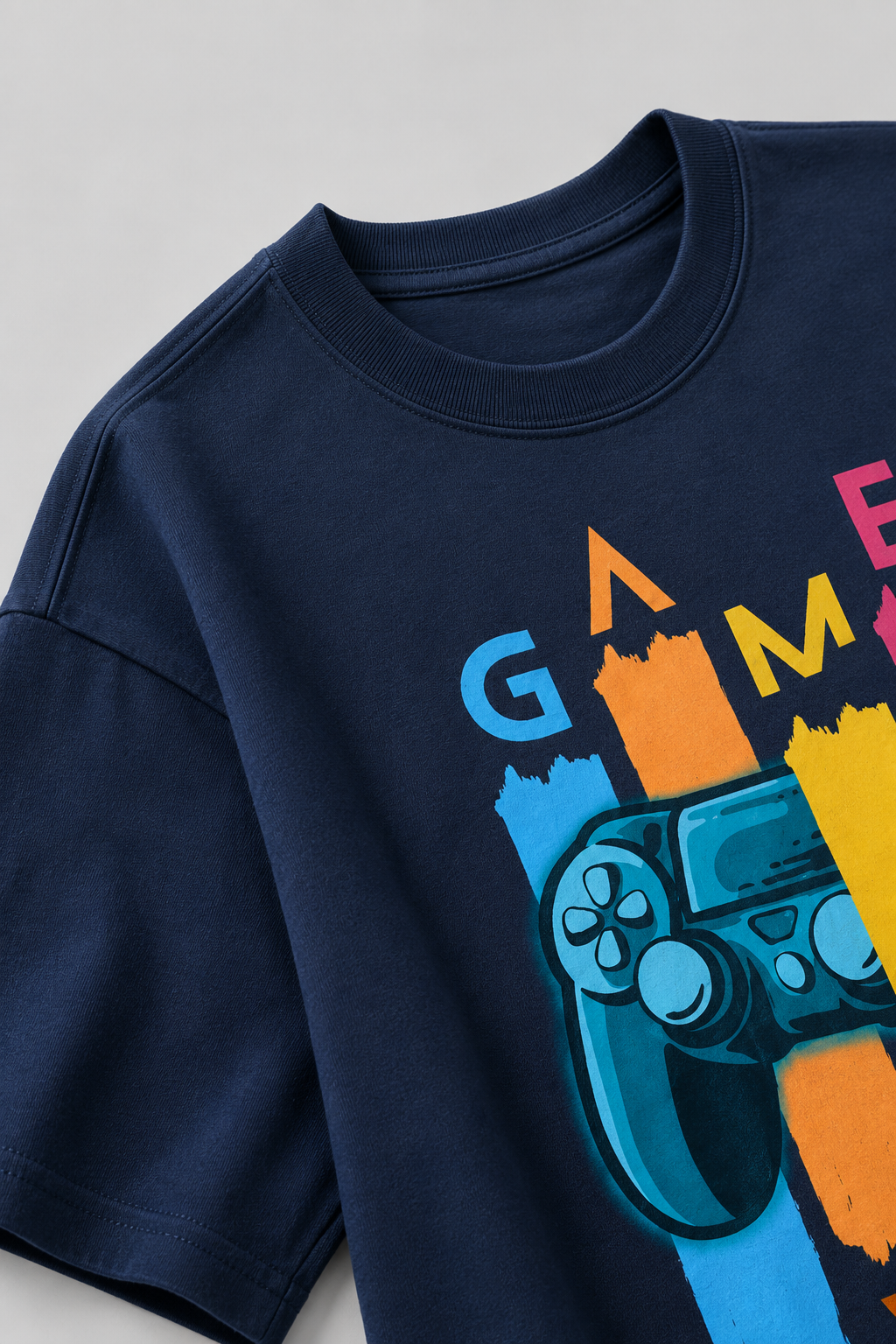 Navy blue t-shirt with colorful gaming graphic on a light gray background