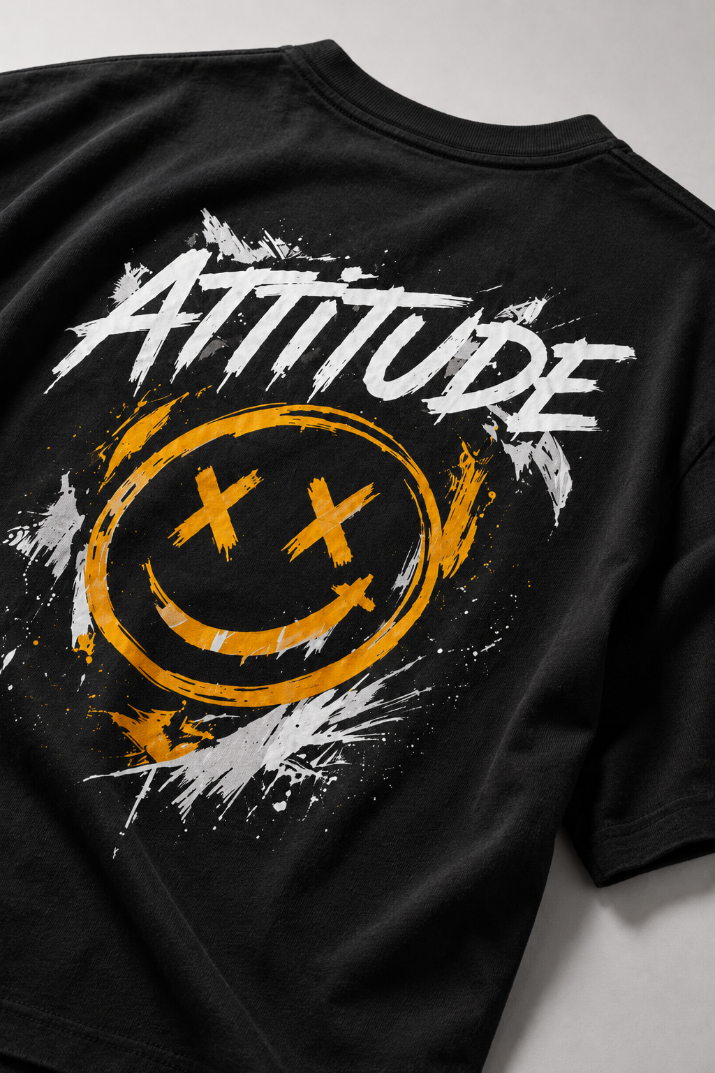 Black t-shirt with 'Attitude' and smiley face design on a gray background