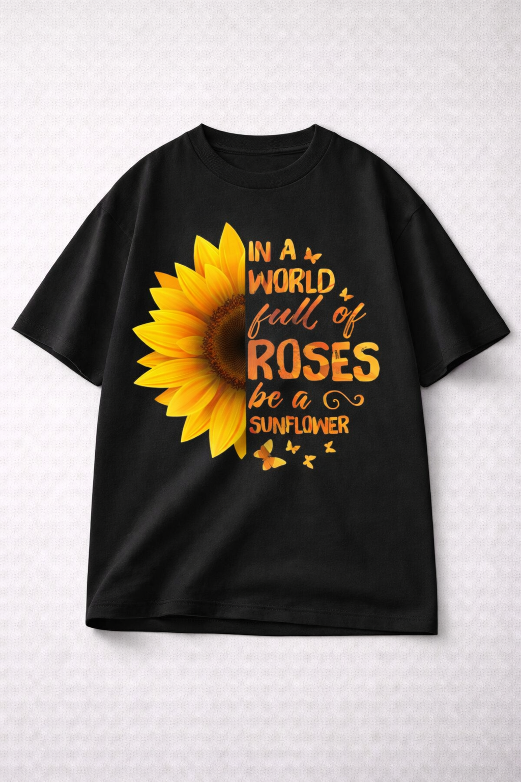 Black t-shirt with a sunflower graphic and text on a light gray background