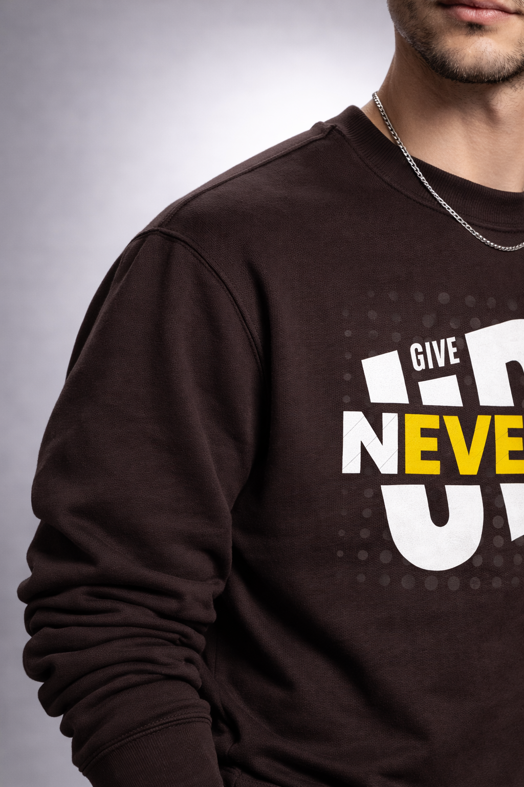 Brown sweatshirt with motivational text on a gray background