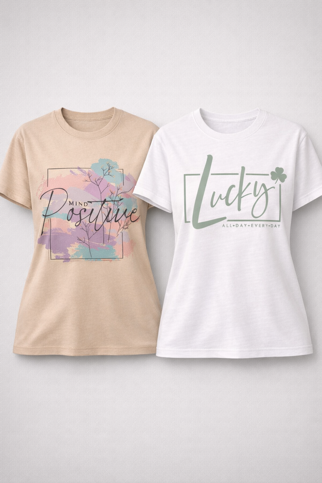Two t-shirts with motivational phrases on a light gray background