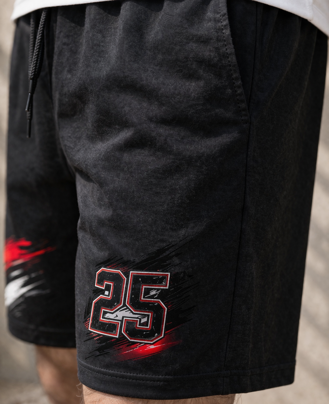 Black shorts with a number 25 design on a neutral background