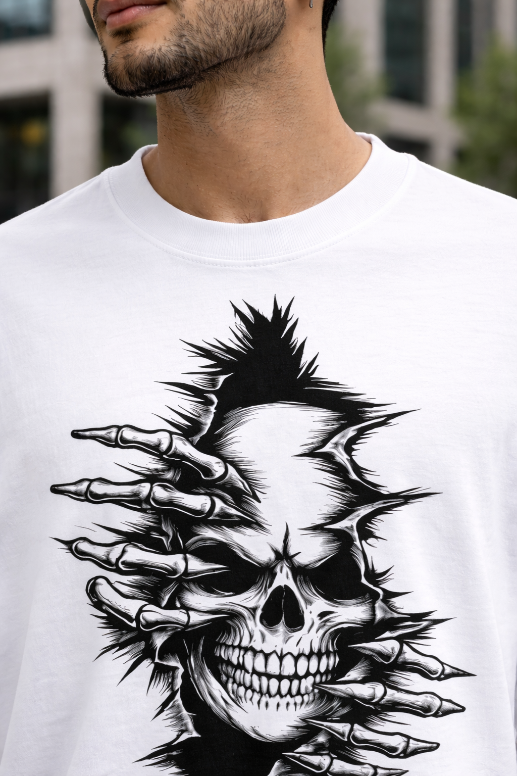 White t-shirt with a black and white skull design on a person outdoors.