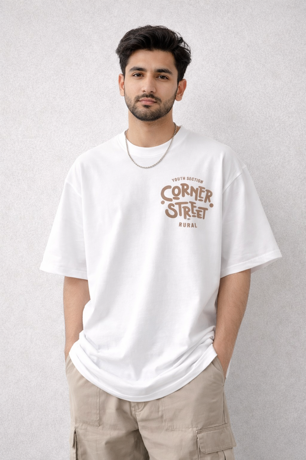 Two white t-shirts with 'Corner Street Rural' print on a carpeted floor.