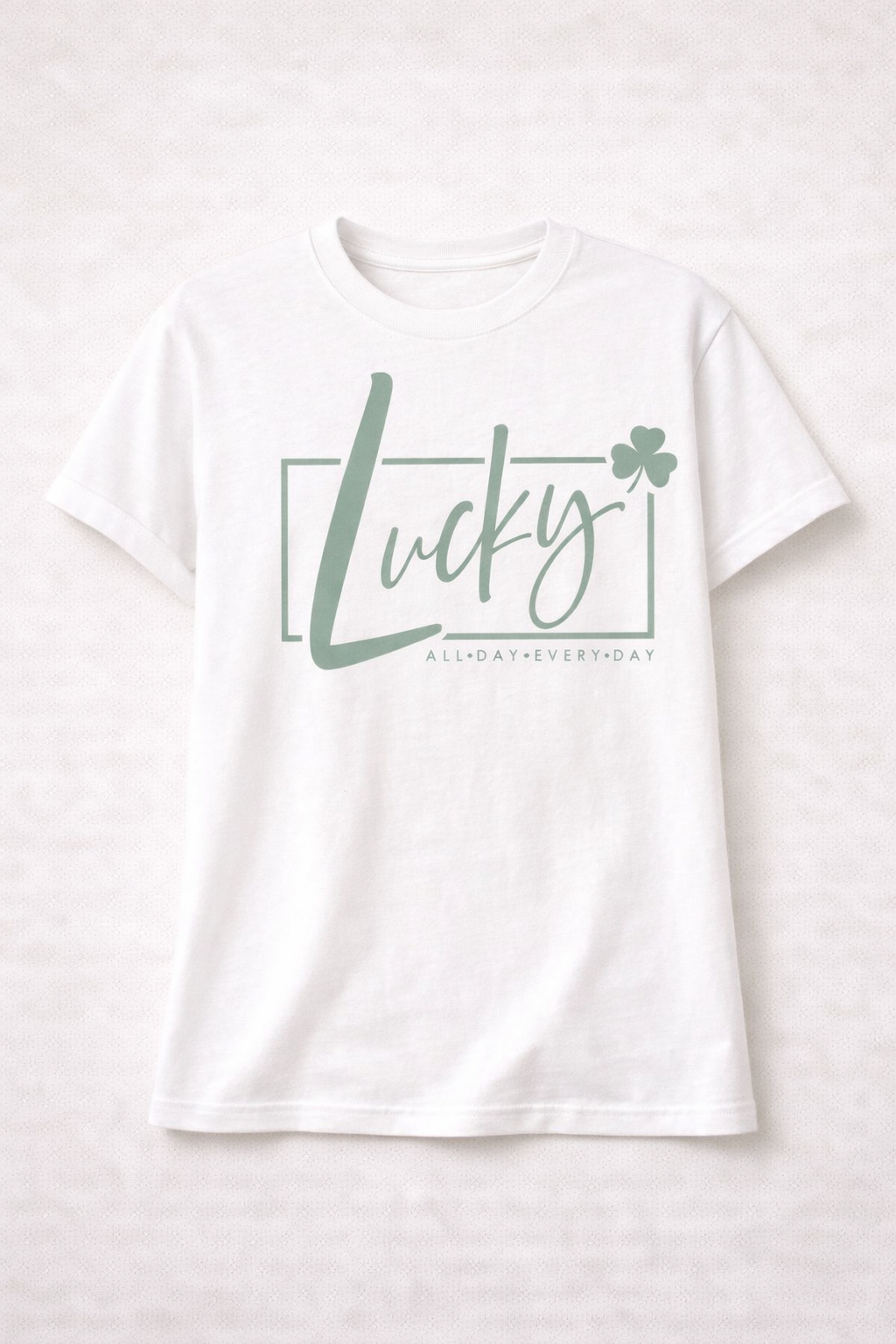 White t-shirt with 'Lucky' and shamrock design on a white background