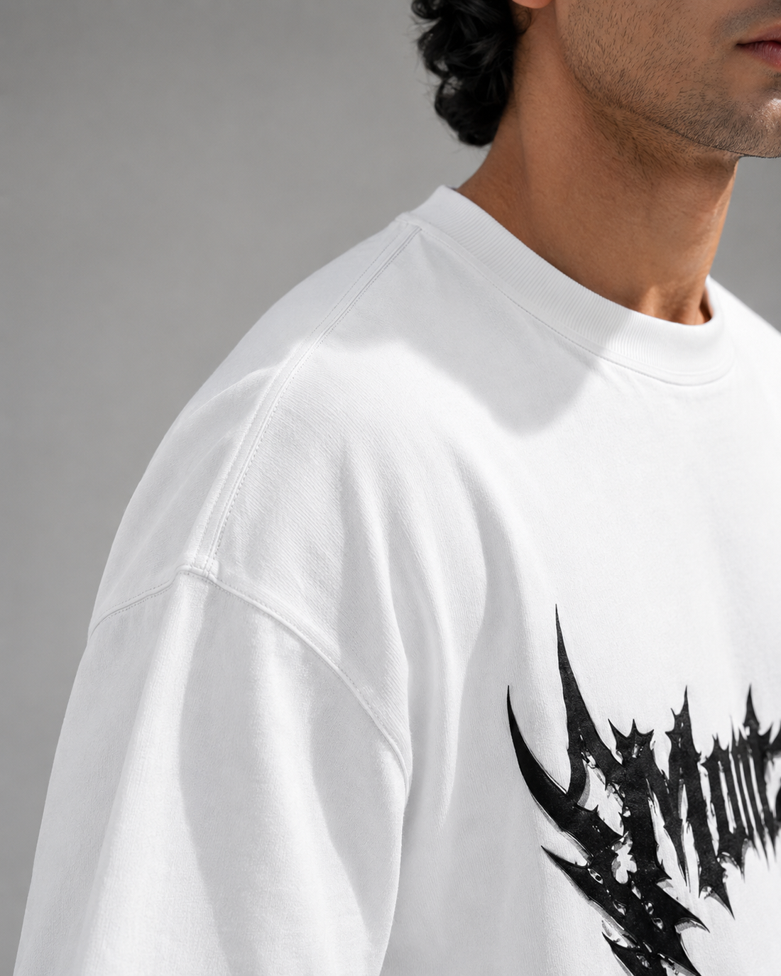 Promotional graphic for a pack of two oversized graphic tees under the heading 'AZADI SALE'. The left tee is white with a black 'Montzxc' graphic, and the right tee is black with a red and black 'THE MASTER PLANNER' graphic.