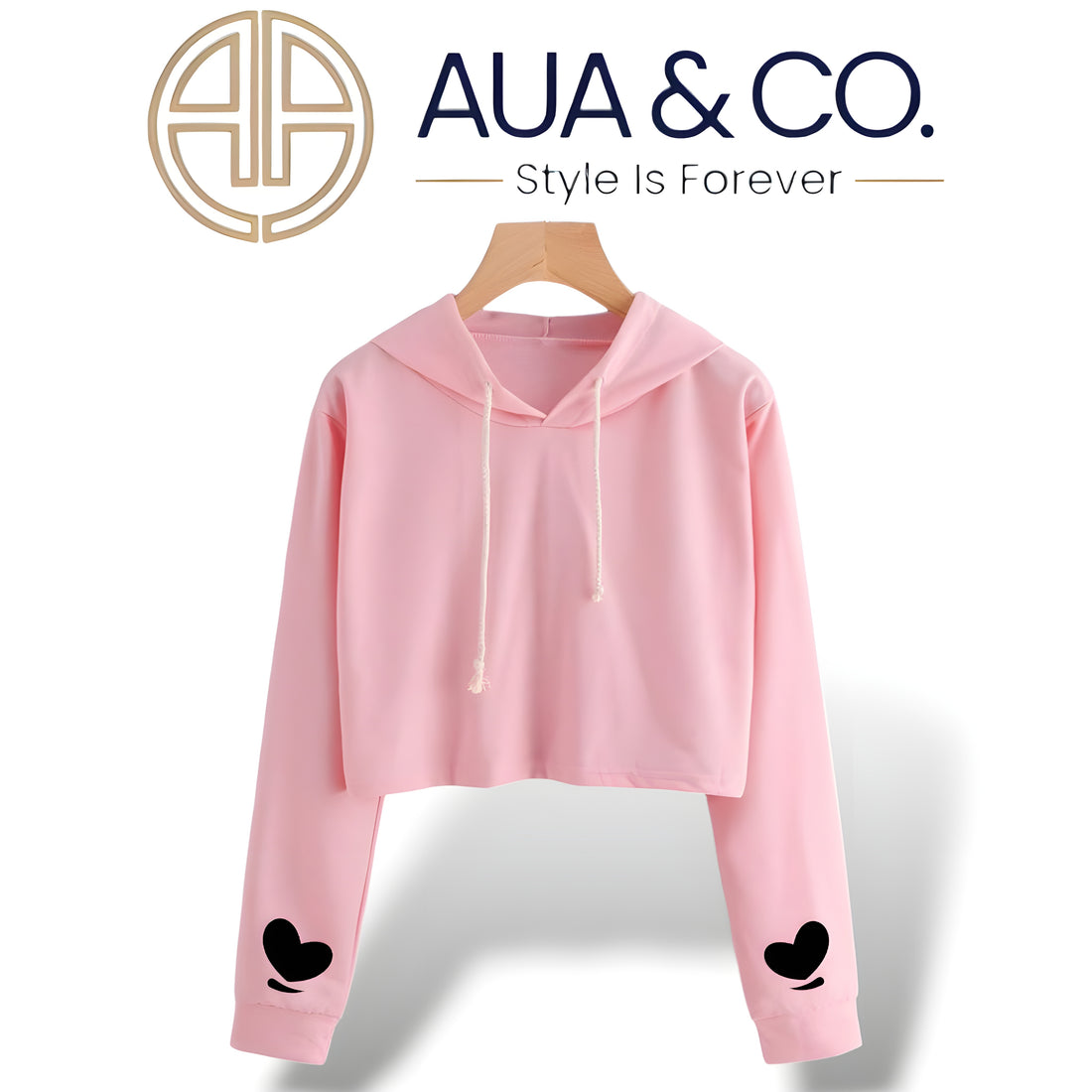 Pink cropped hoodie for women by AUA & CO, featuring black heart designs on the sleeves, made from high-quality fleece fabric for a stylish and cozy winter look